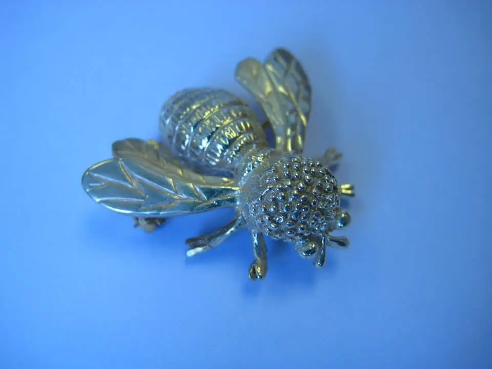 A hand-crafted silver and gold bee brooch by Jennie the Jeweller