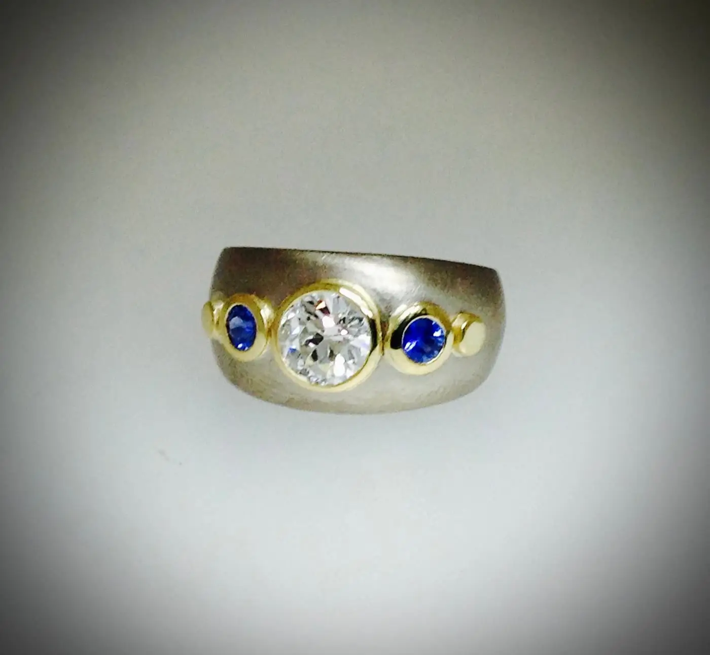 A finished diamond and sapphire gypsy-set ring by Jennie the Jeweller