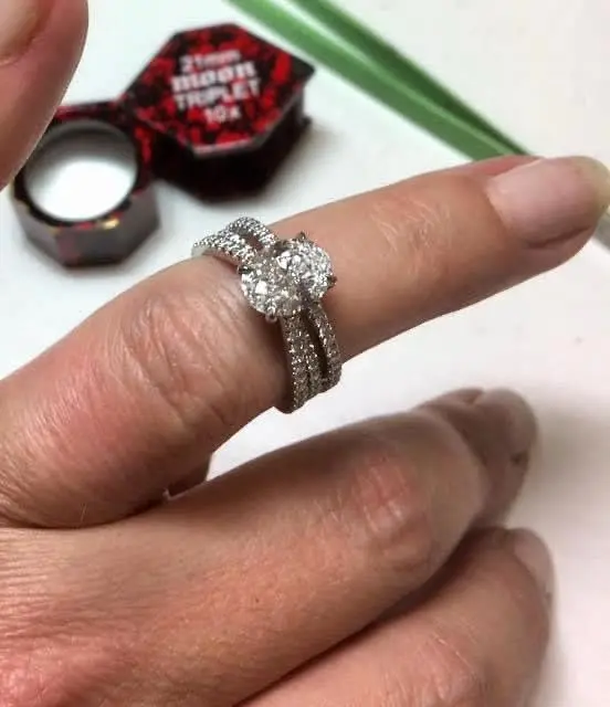 A diamond solitaire ring by Jennie the Jeweller, shown with its presentation box