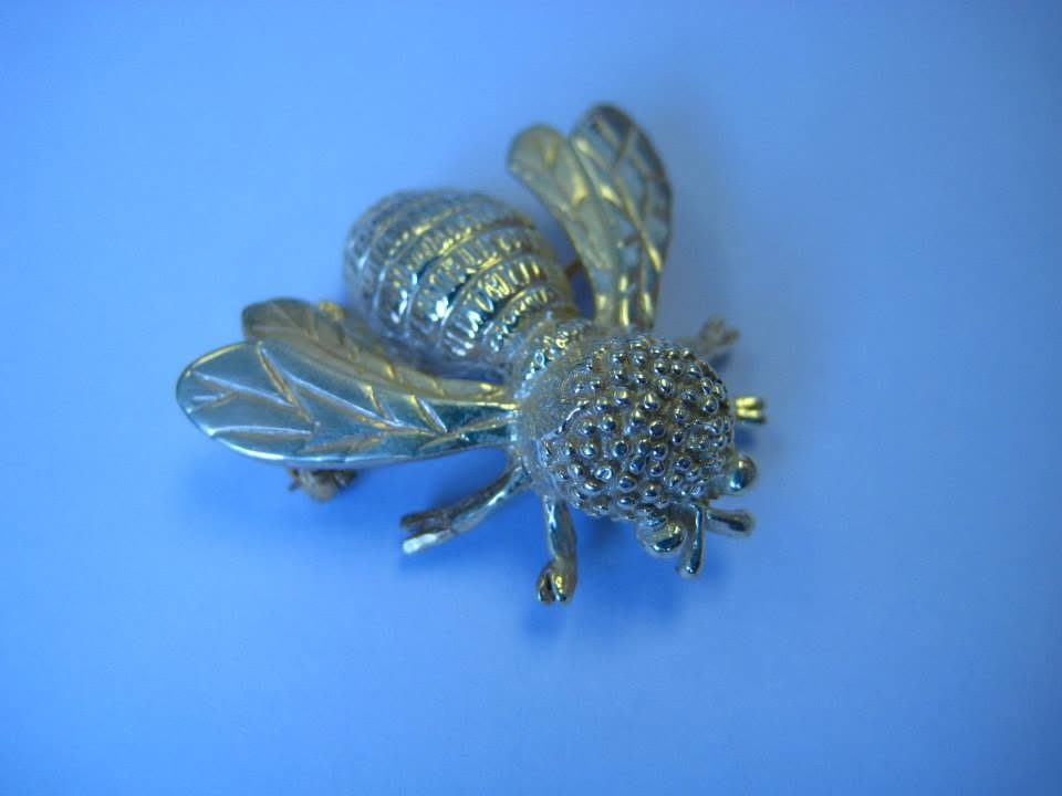 A hand-crafted silver and gold bee brooch by Jennie the Jeweller